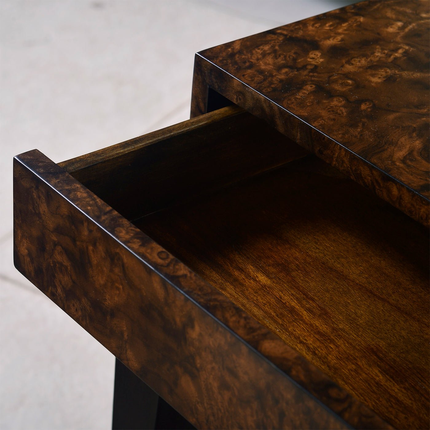 Interior close-up of open drawer in walnut console.