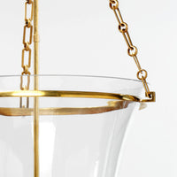 Cloche lantern focus, brass chain and glass rim close-up.