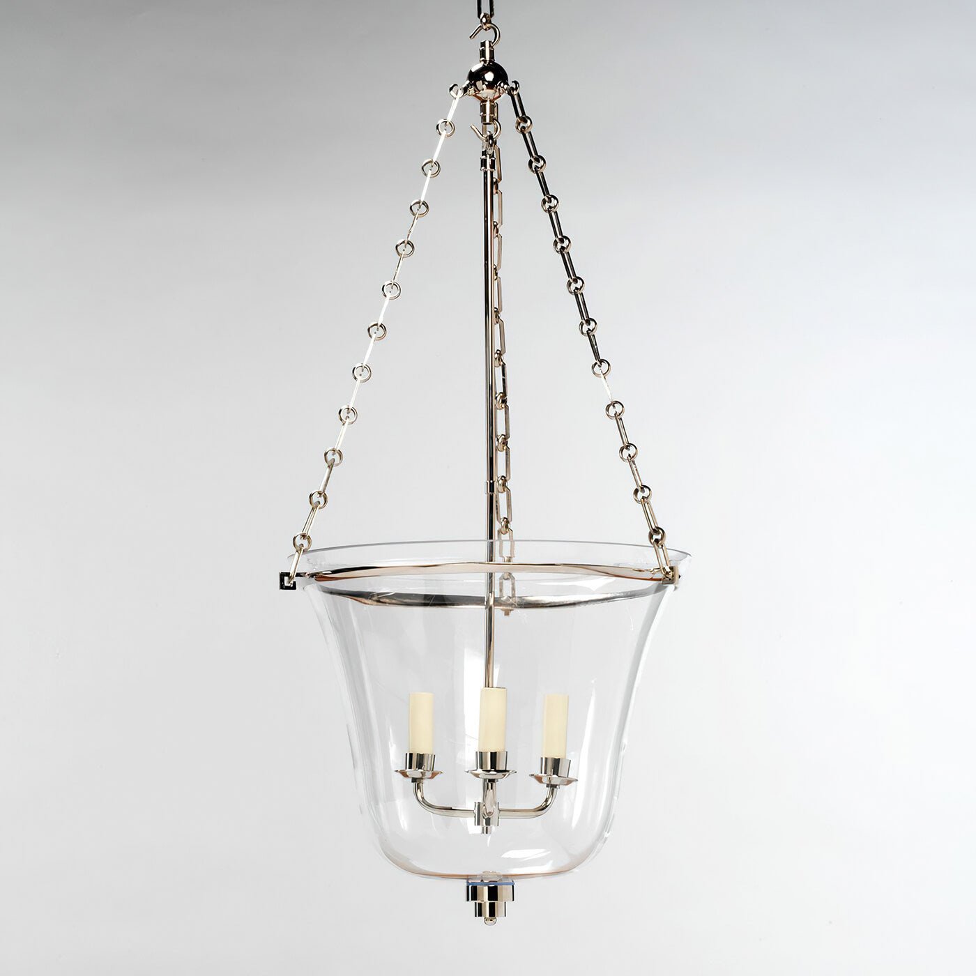 Hanging cloche lantern, nickel, against plain background.