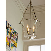 Cloche lantern lighted, hung in modern interior.
