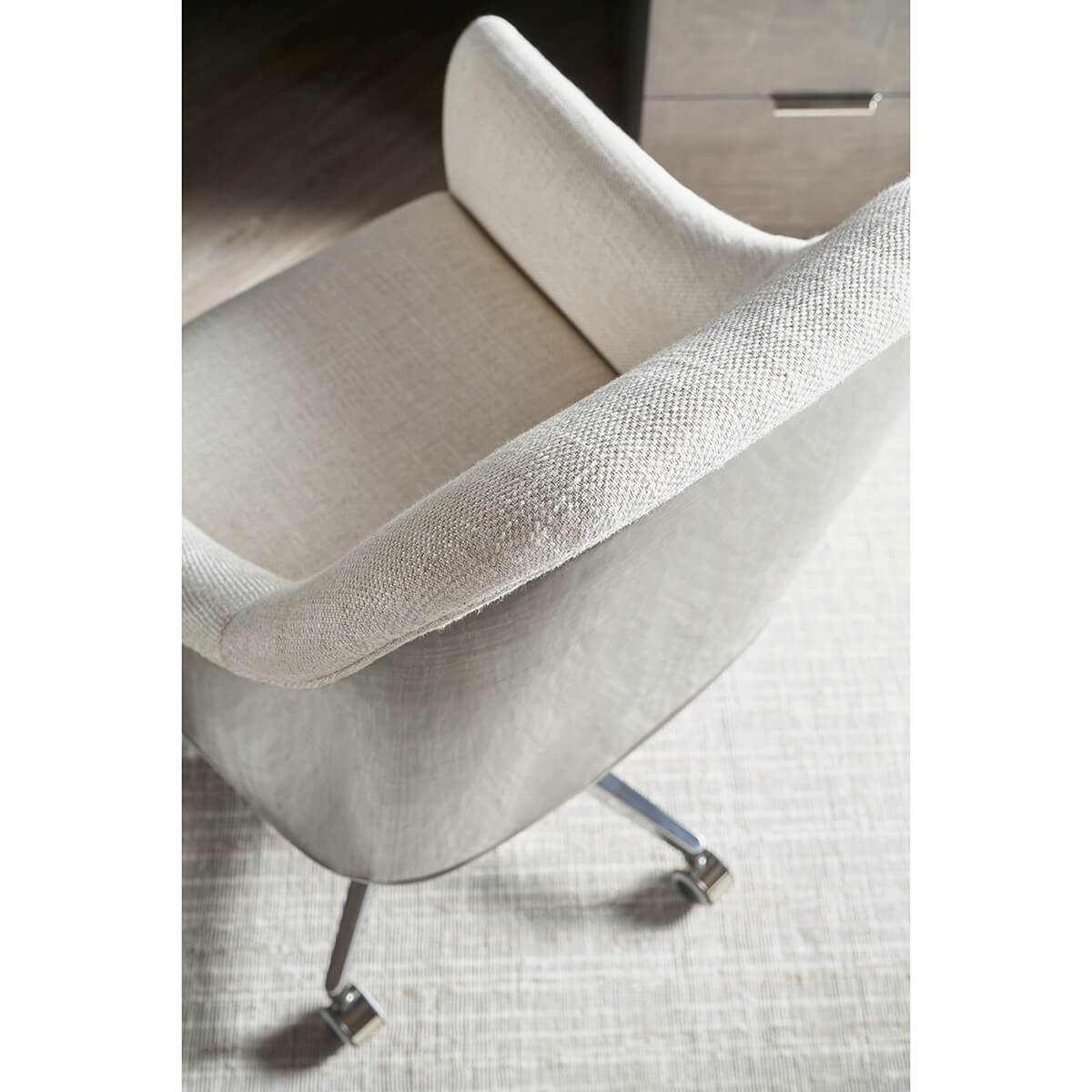 Art Deco desk chair top view, soft beige cushioning.