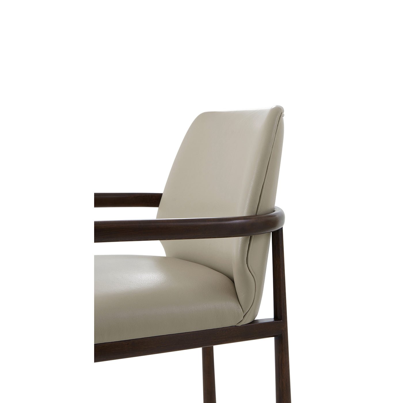 Close-up of beige leather dining armchair, arm and back detail.