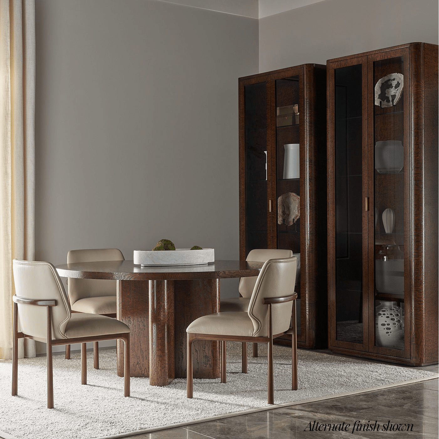 Dining room with beige chairs and wooden table.