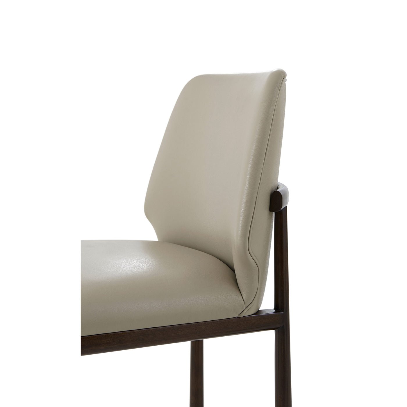 Beige leather dining side chair, detail of backrest.