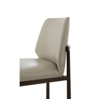 Beige leather dining side chair, detail of backrest.