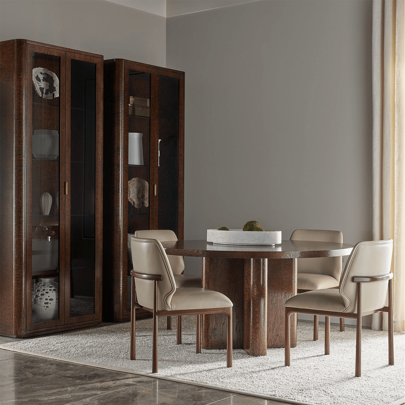 Dining area with beige leather side chairs and table.