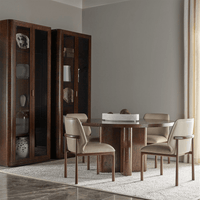 Dining area with beige leather side chairs and table.