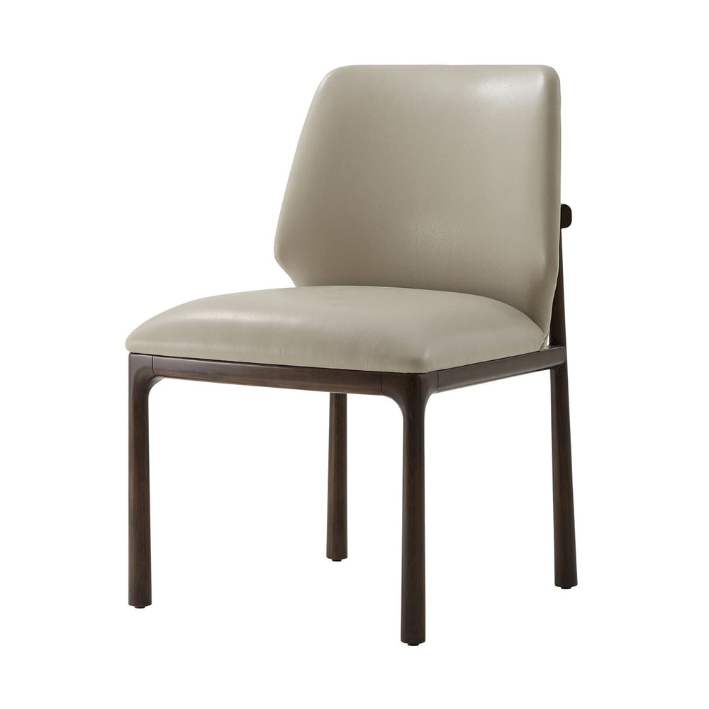 Beige leather dining side chair, three-quarter front view.