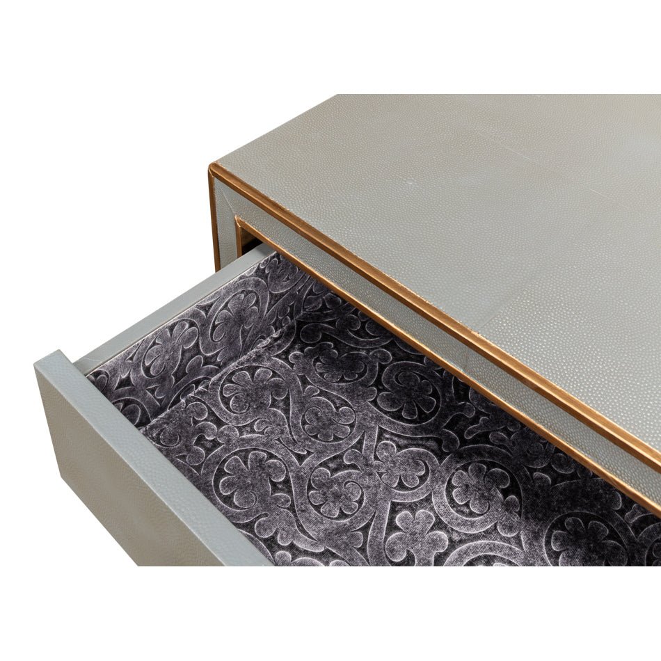 Open drawer with decorative interior pattern.