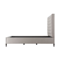 Side profile of gray tufted queen bed frame.