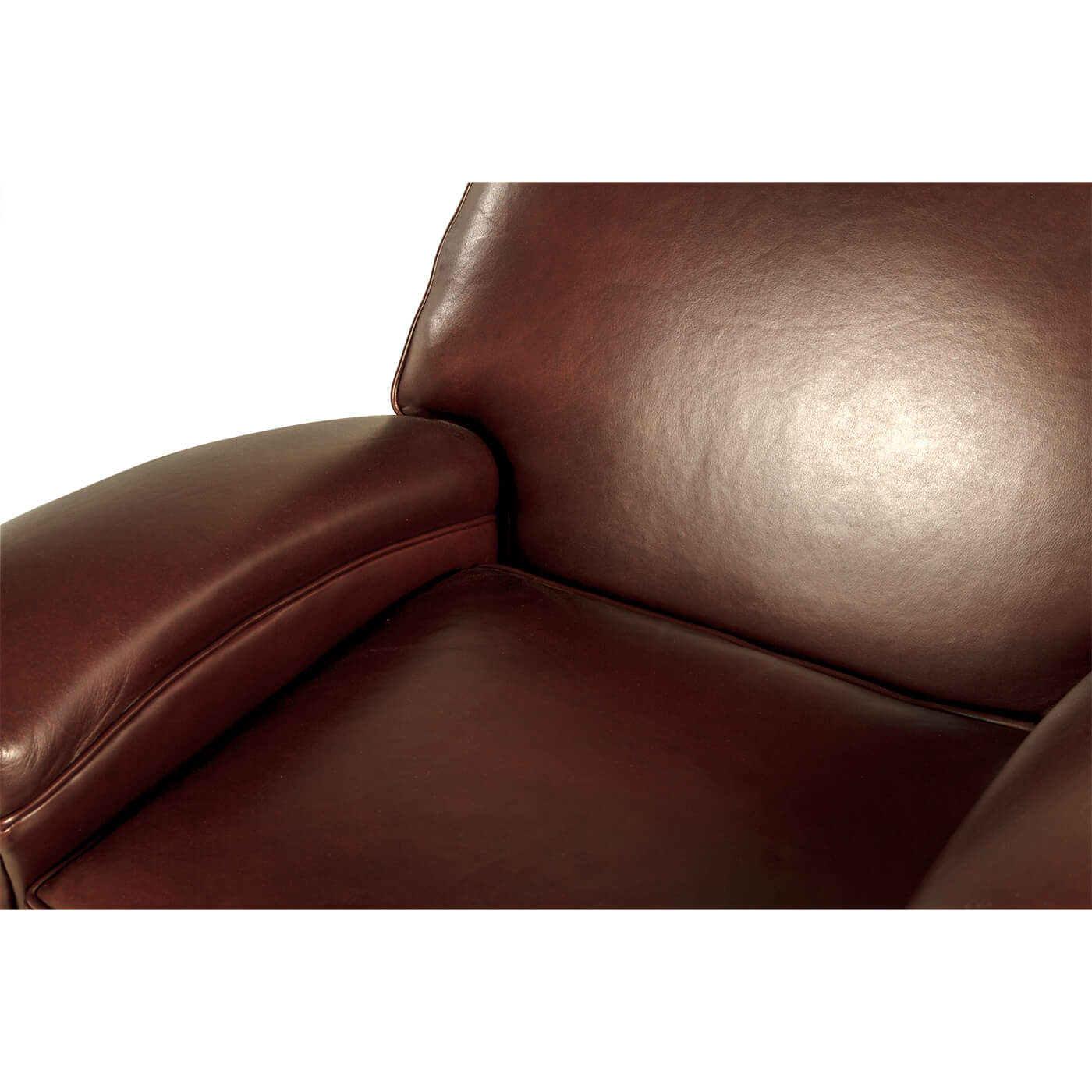 Close-up of backrest and armrest on leather club chair.