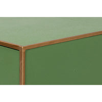 Edge detail of green table with brass frame