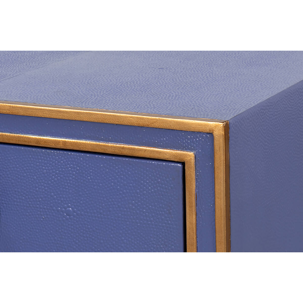 Corner detail of Art Deco leather desk with gold trim.