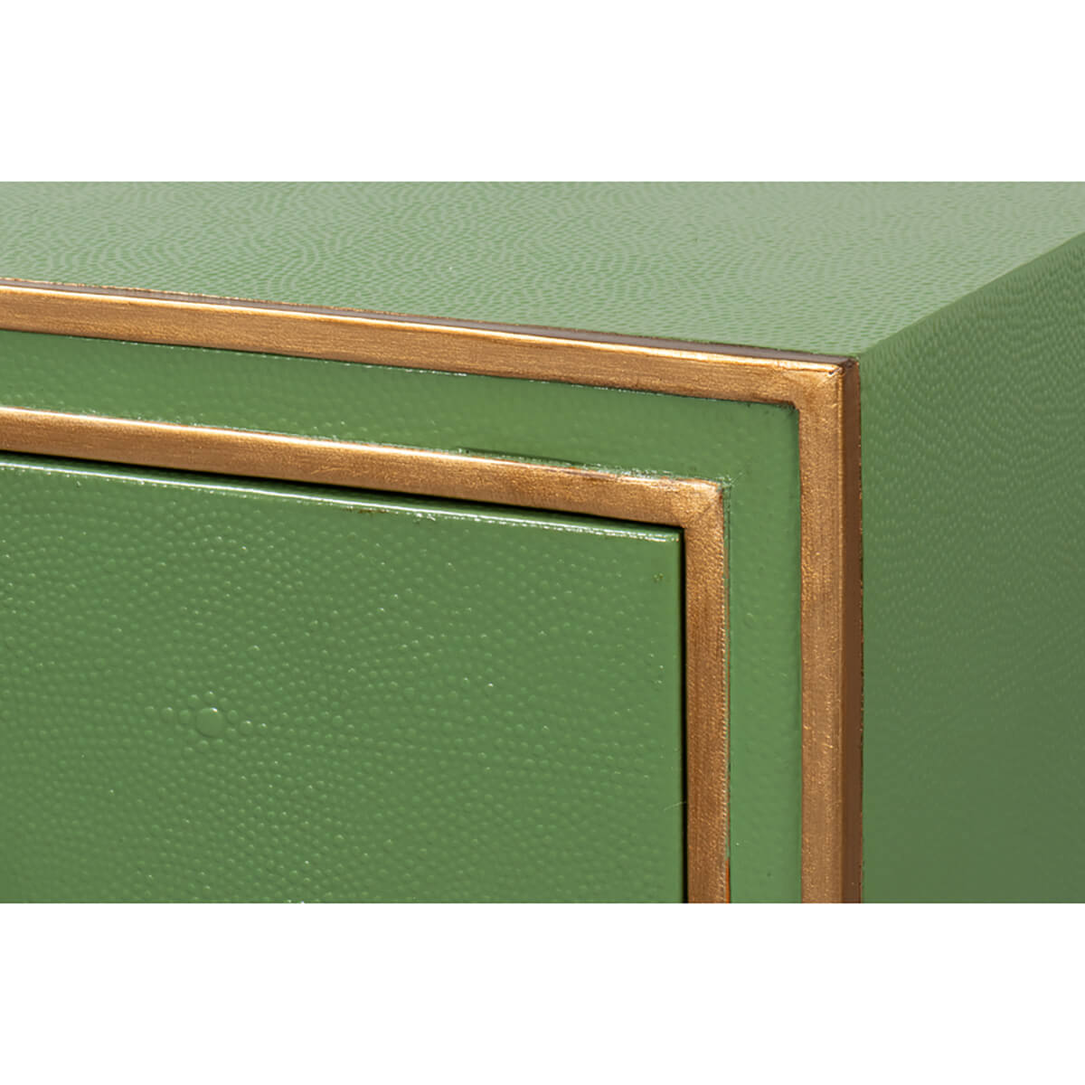 Close-up of gold accents on green desk corner