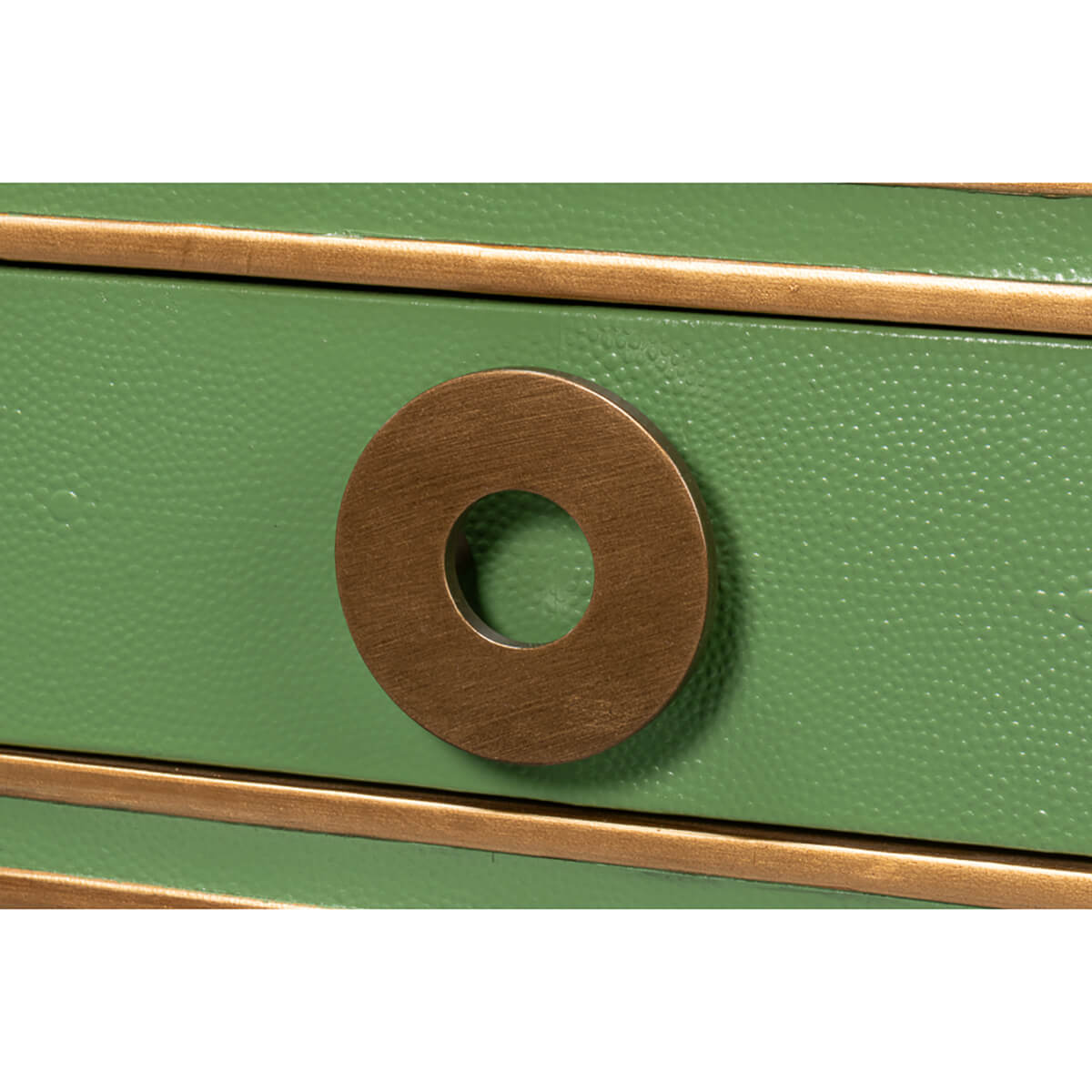 Close-up of circular drawer handle on green desk