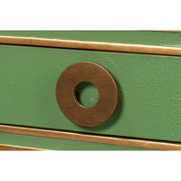 Close-up of circular drawer handle on green desk