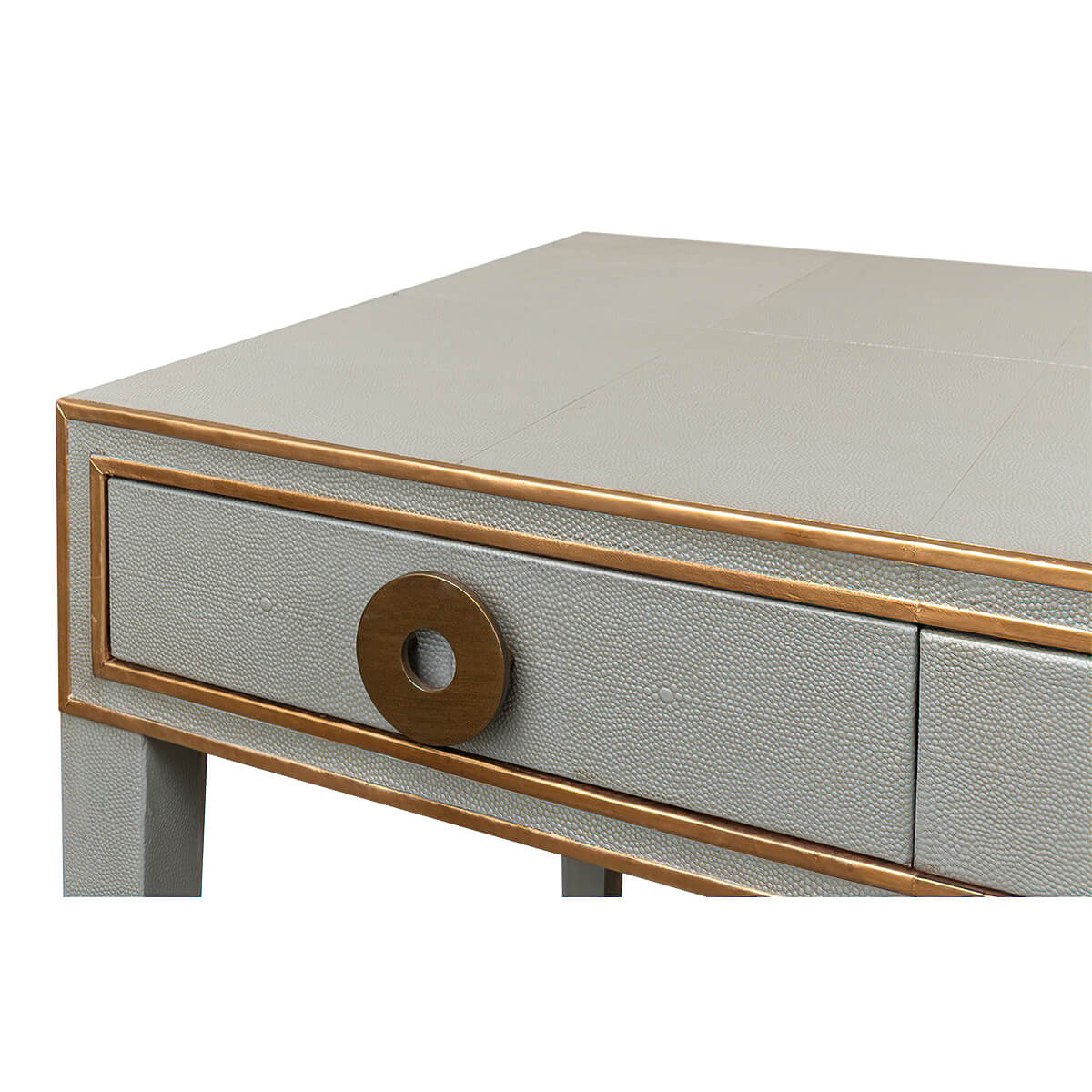 Close-up of desk drawer with bronze circular handle.