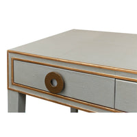 Close-up of desk drawer with bronze circular handle.