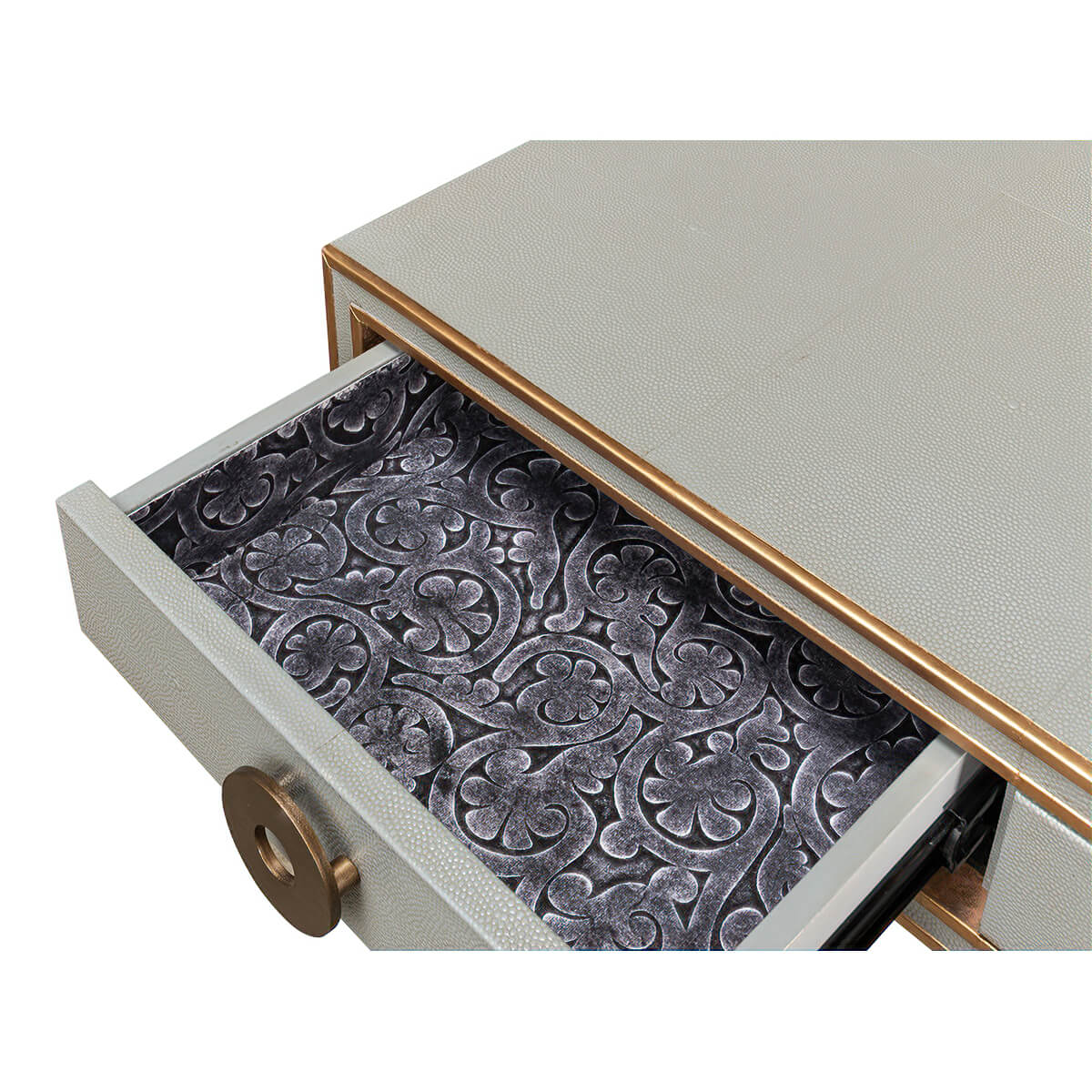 Open desk drawer, ornate interior lining design.