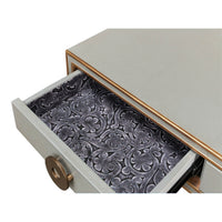 Open desk drawer, ornate interior lining design.