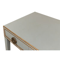 Close-up of desk surface, light grey leather texture.