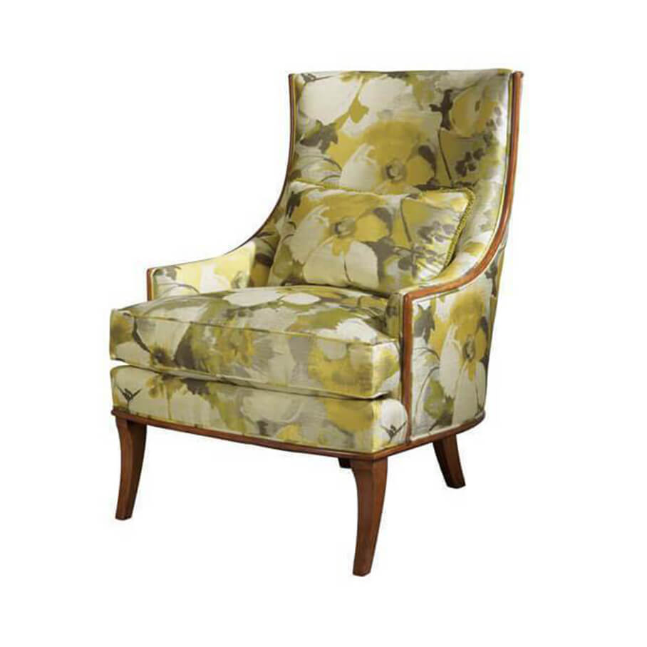 Floral patterned scoop back armchair, side angle view.