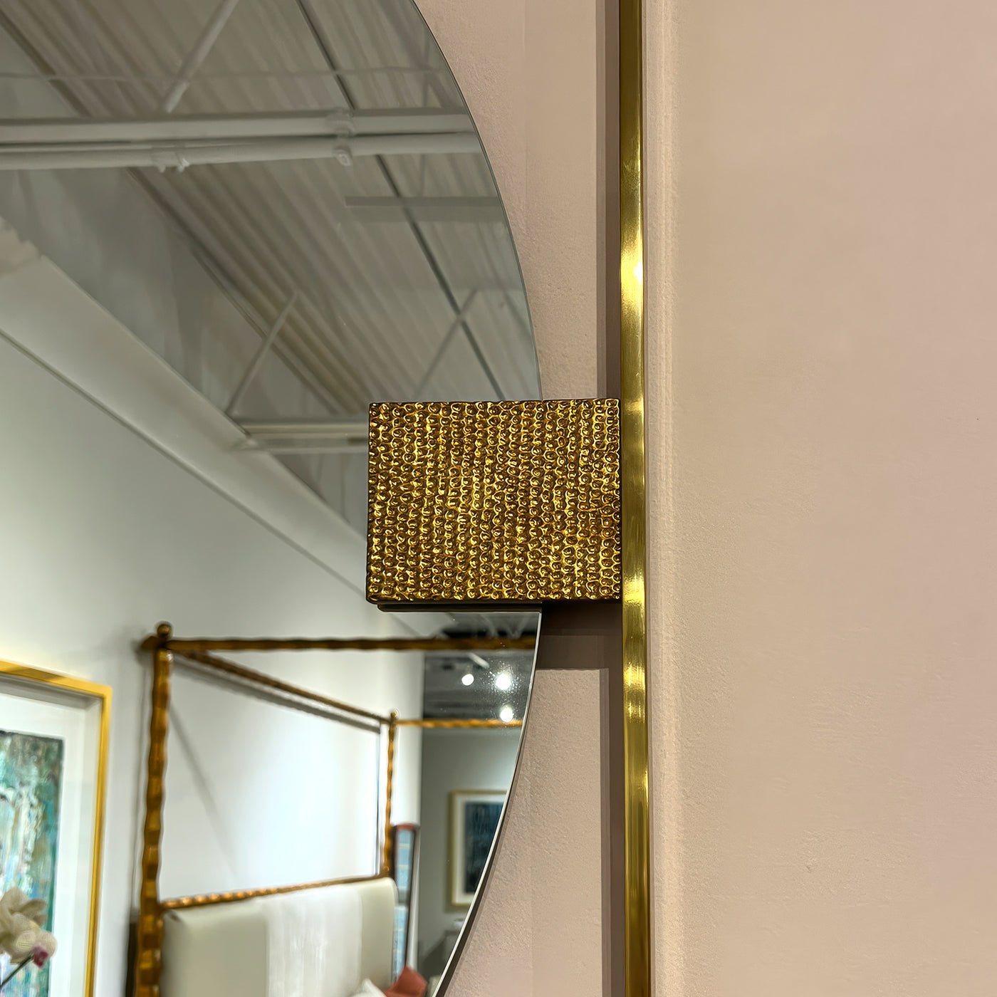 Detailed view of textured gold accent on mirror.