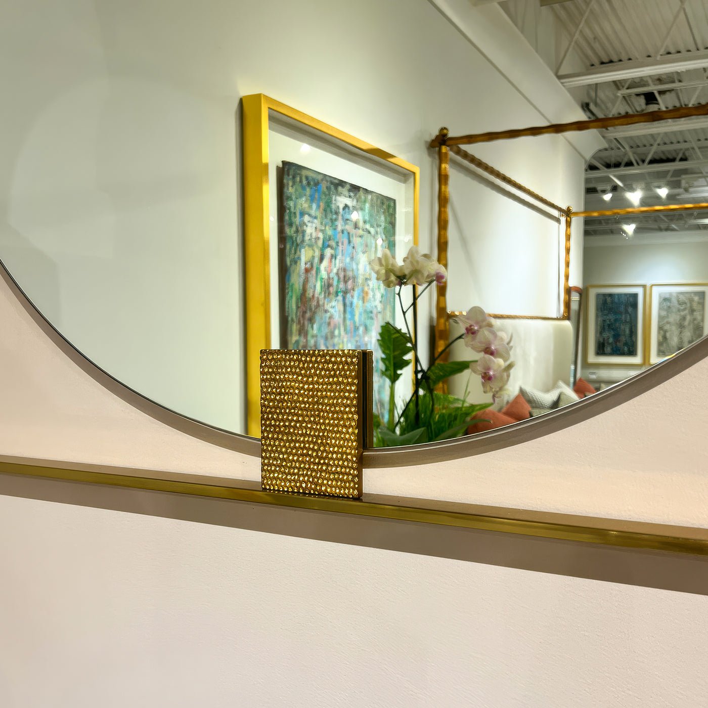 Close-up of mirror's gold accent against interior background.