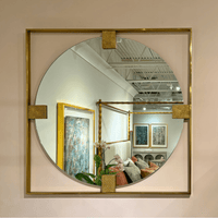 Art Deco brass mirror reflecting interior decor and lighting.