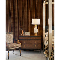 Burl wood dresser in a room setting with lamp.