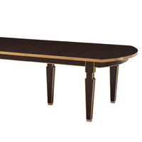 Extension dining table corner detail, dark wood finish.