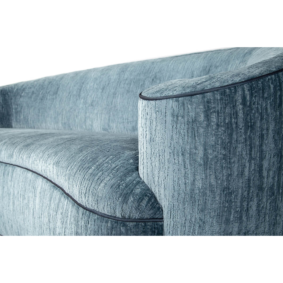 Close-up of armrest on art deco style scroll sofa.