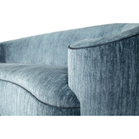 Close-up of armrest on art deco style scroll sofa.