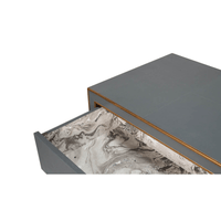 Open drawer showing marbled design, grey dresser.