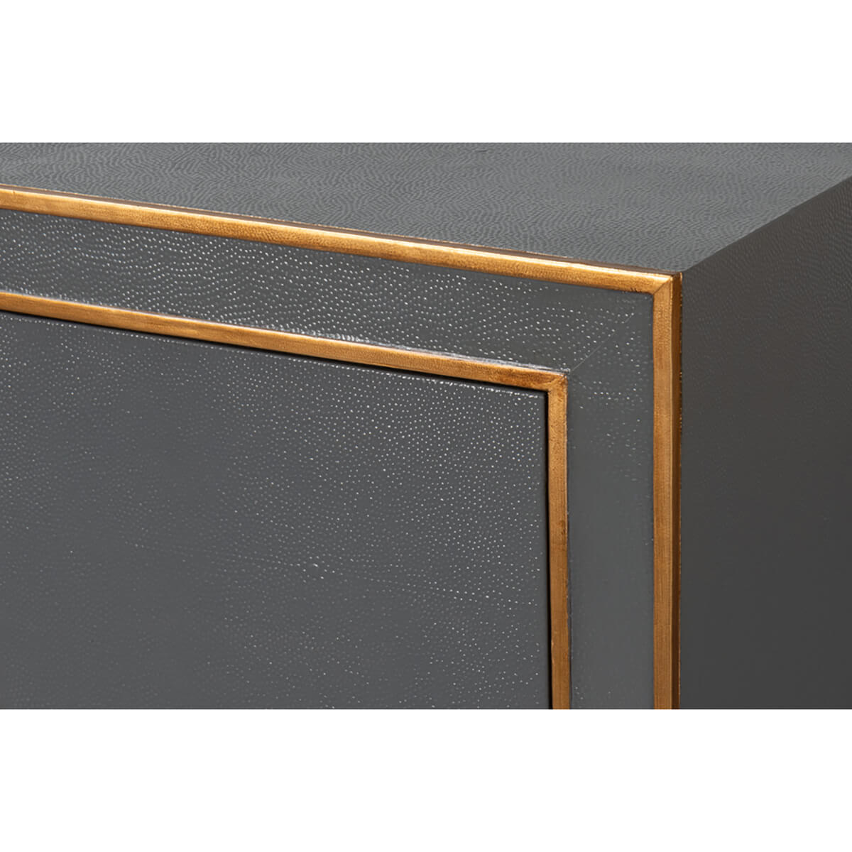 Close-up grey dresser corner, brass detail.