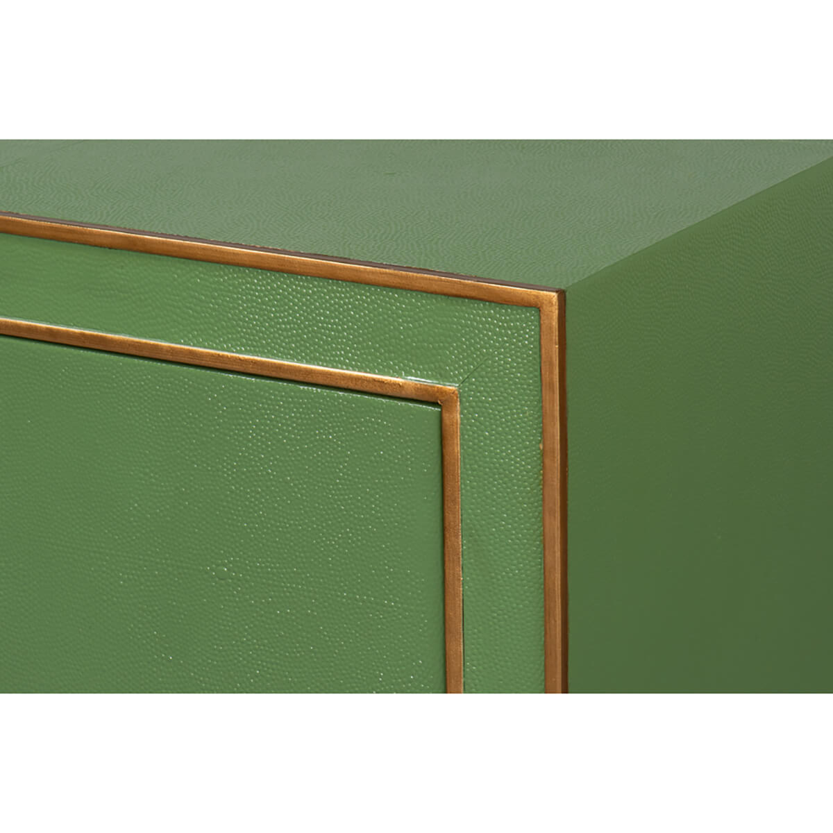 Corner close-up of dresser with bronze trim detail.