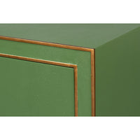 Corner close-up of dresser with bronze trim detail.