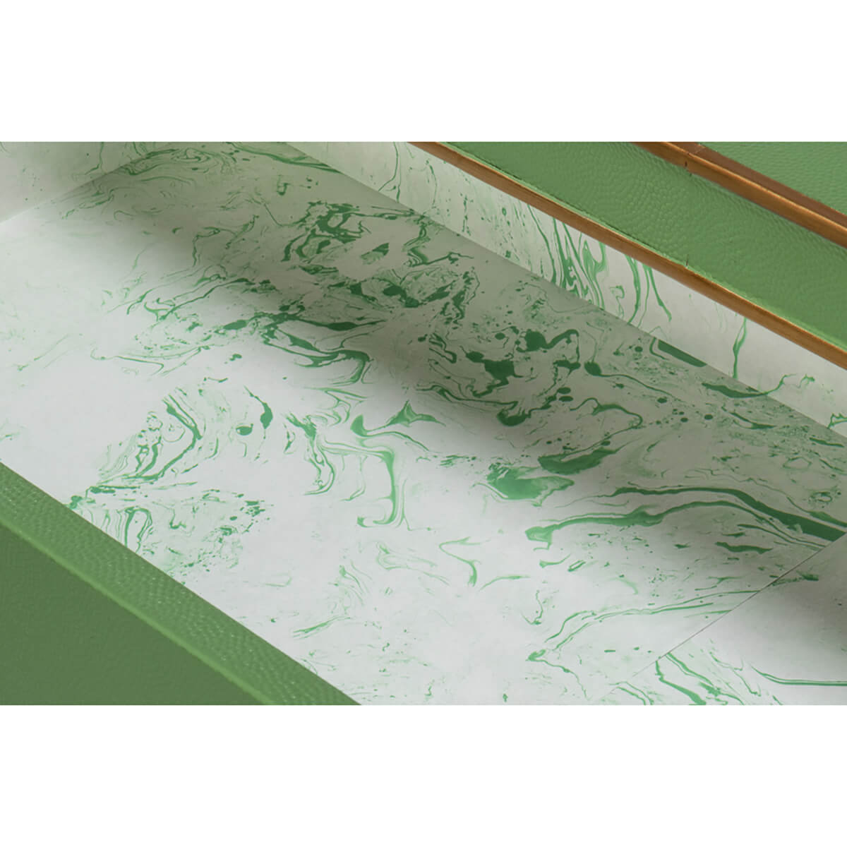 Interior drawer with green marbled paper lining.