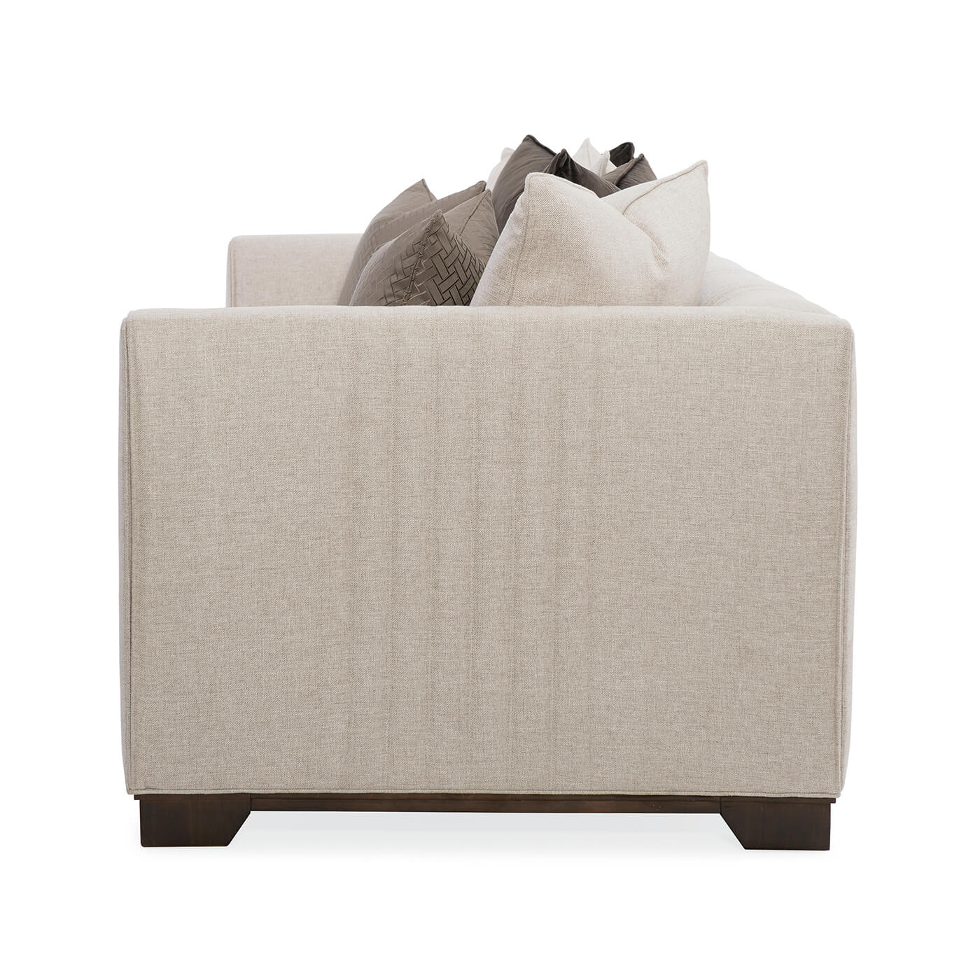 Beige sofa with pillows, side profile view.