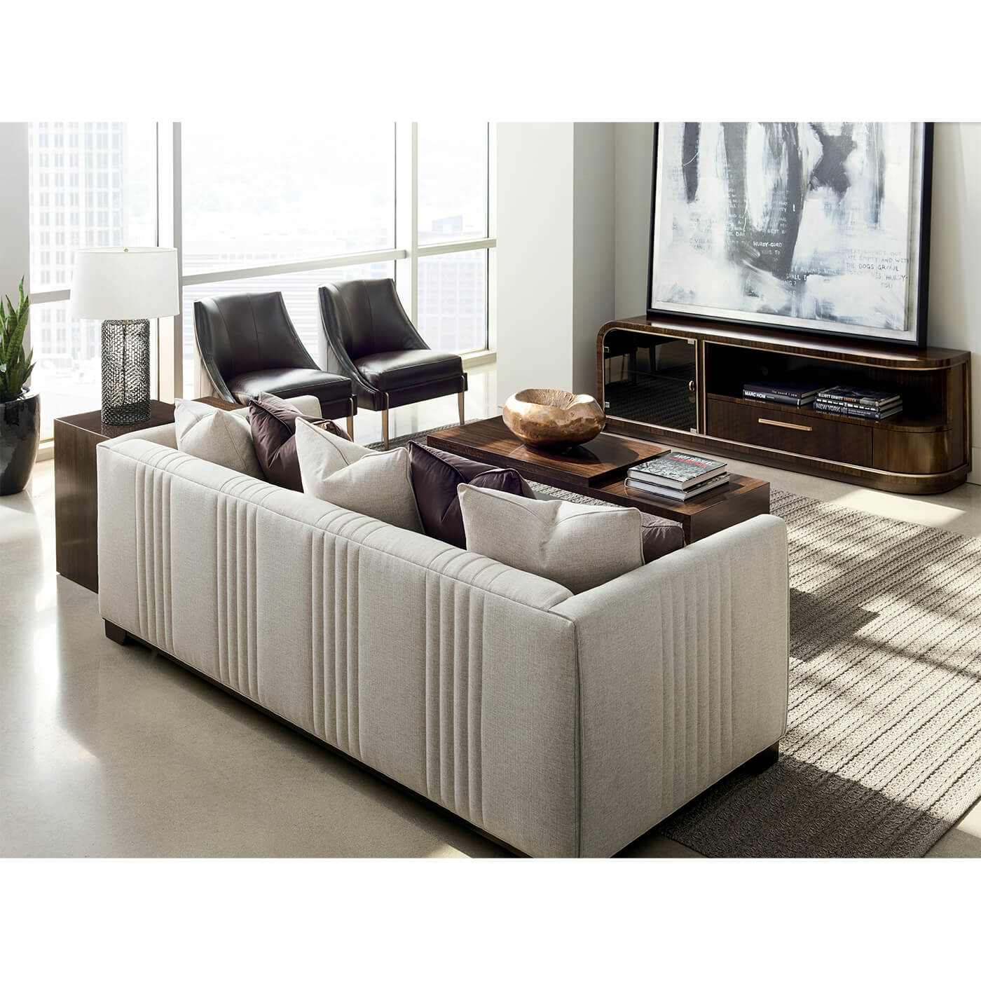 Beige sofa in living room, city view in background.