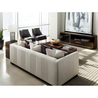 Beige sofa in living room, city view in background.