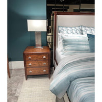 Art Deco bed with wooden nightstand and lamp