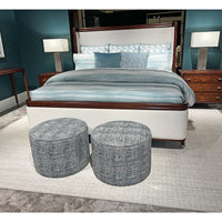 Art Deco bed with blue bedding and ottomans