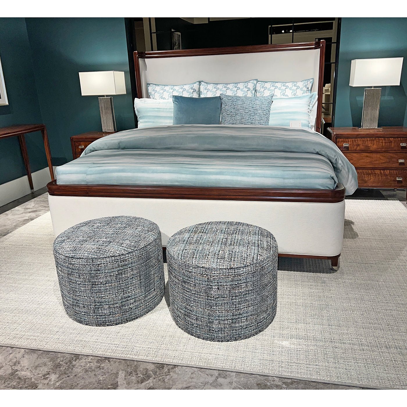 Upholstered bed with blue bedding, California King size.