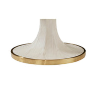 Base of white center table featuring gold trim, close-up.