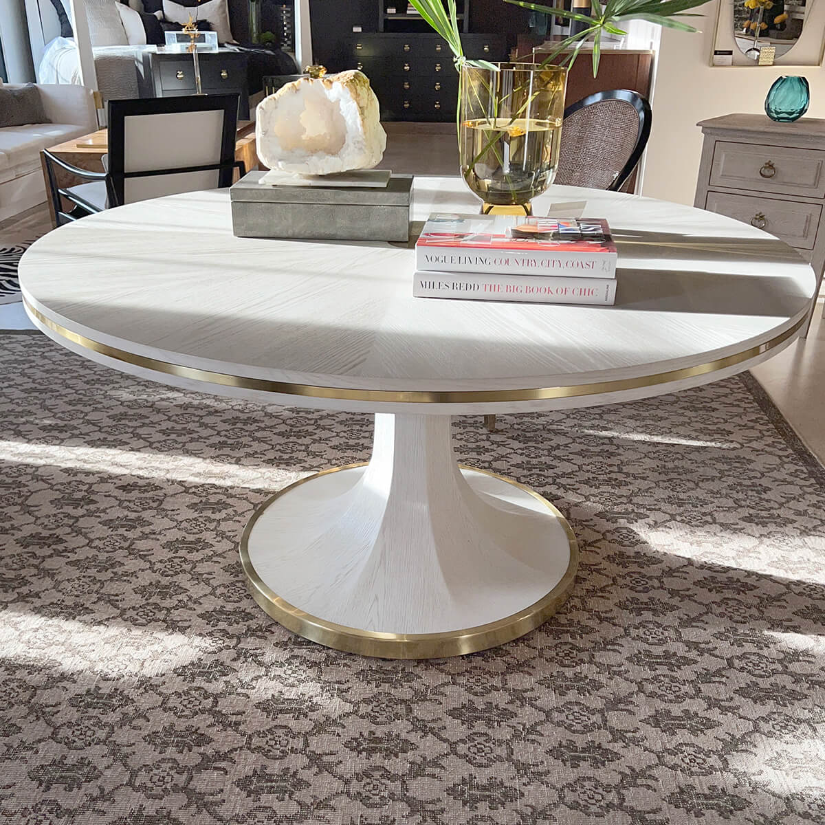 White dining table in cozy living space with decor.