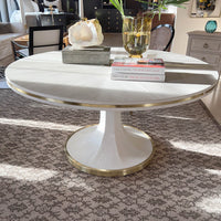 White dining table in cozy living space with decor.