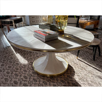 Stylish white dining table in sunlit interior setting.