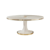 Elegant white dining table with brass accents, side view.