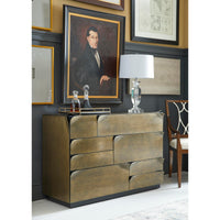 Brass dresser in room setting, decorative items on top.